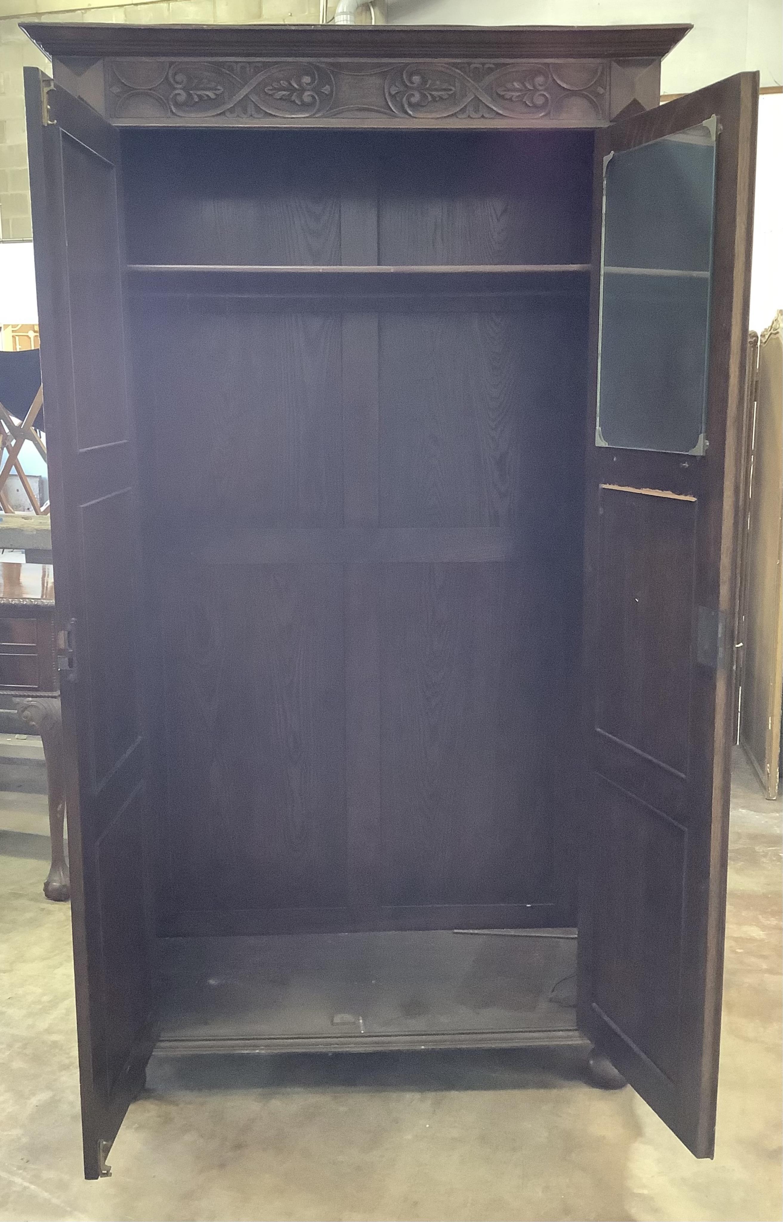 A 17th century style carved oak wardrobe, width 112cm, depth 46cm, height 197cm. Condition - fair